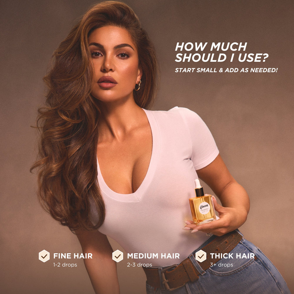 Negin Mirsalehi holding the hair oil bottle. 